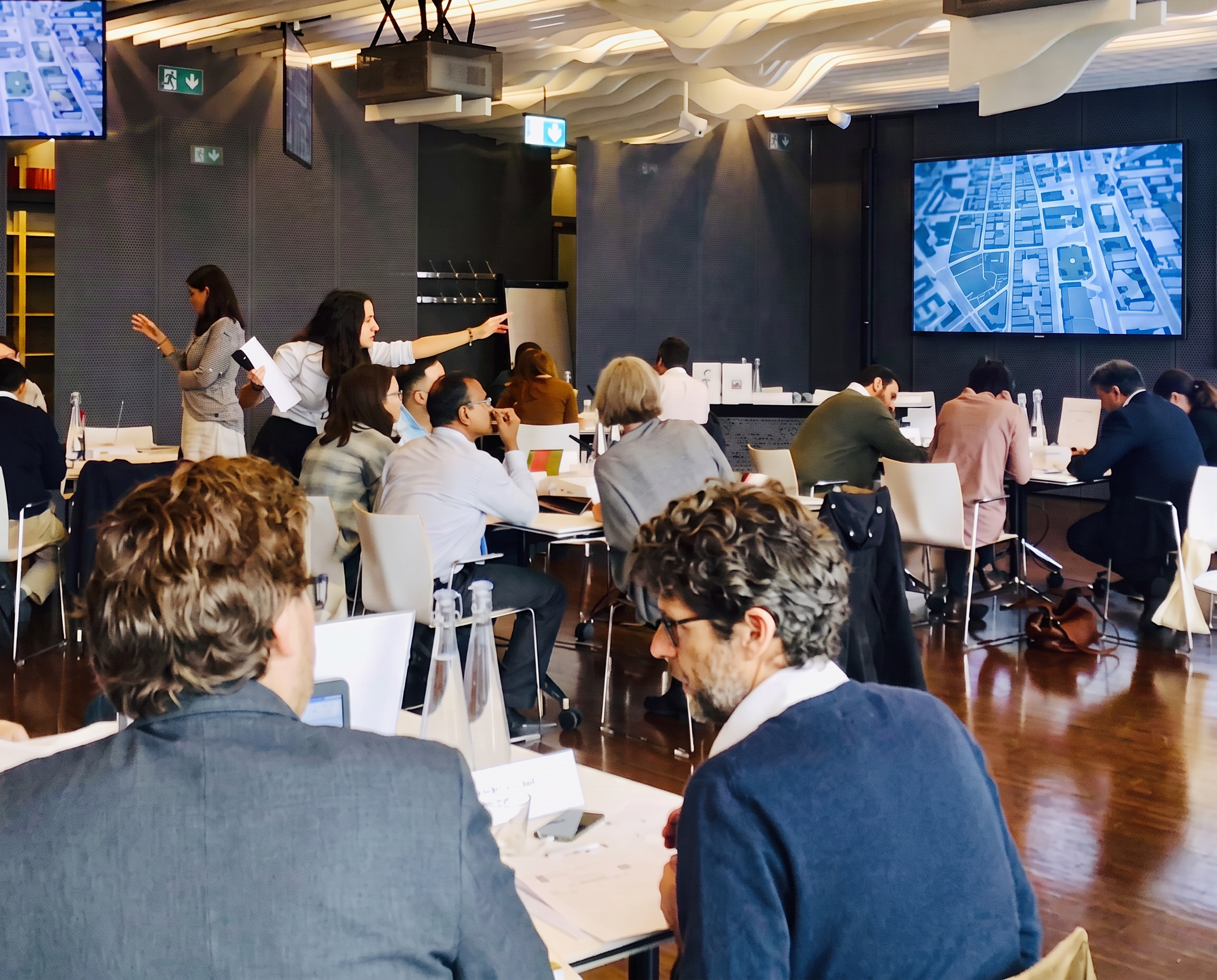 Taline facilitating a case study session with digital tools in a conference room