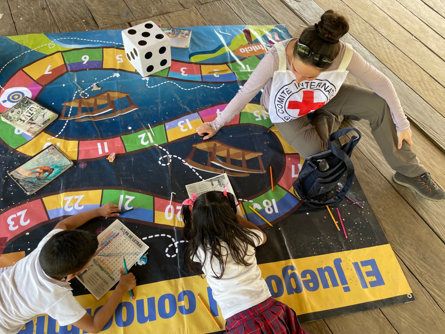 Taline playing an educational board game with children